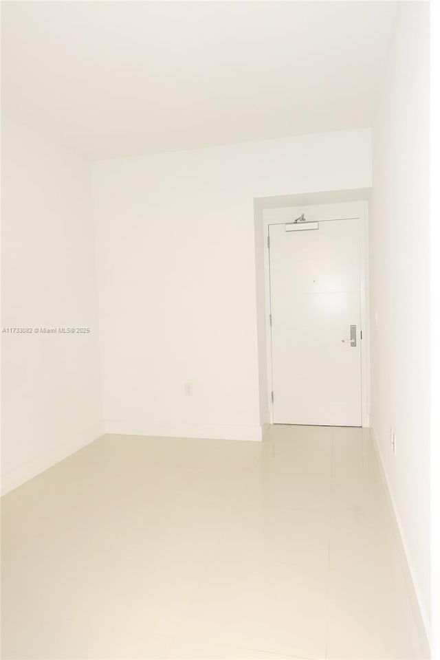 unfurnished room featuring tile patterned flooring