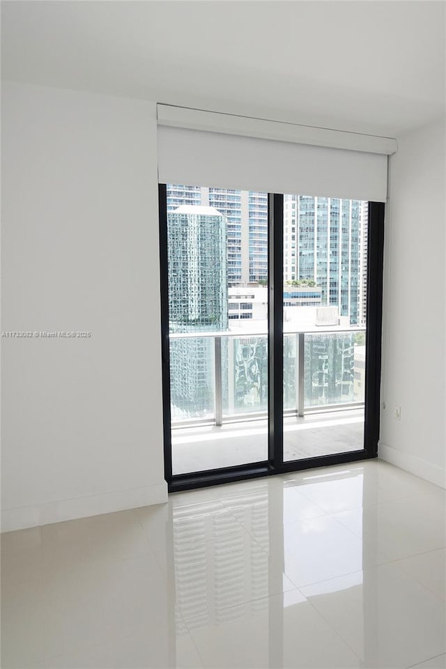 tiled empty room with floor to ceiling windows