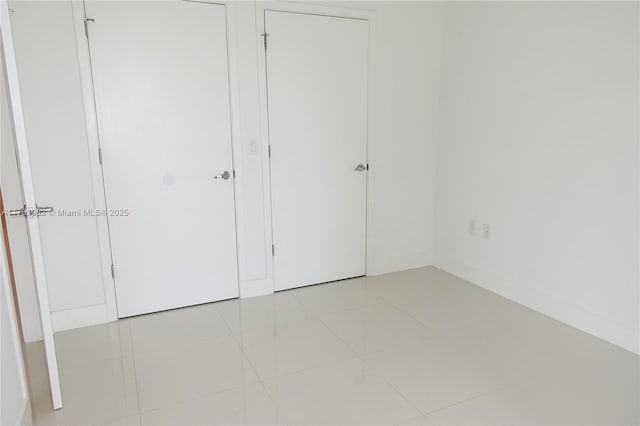 unfurnished bedroom with light tile patterned floors