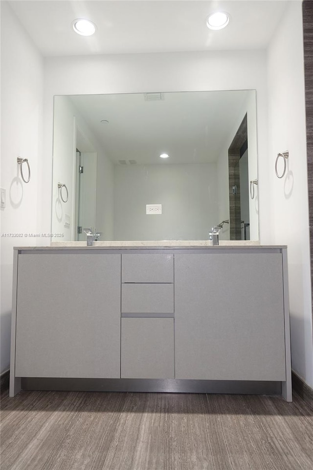 bathroom featuring wood-type flooring and vanity