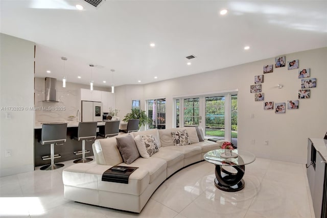 entrance foyer featuring tile patterned flooring, a towering ceiling, and french doors