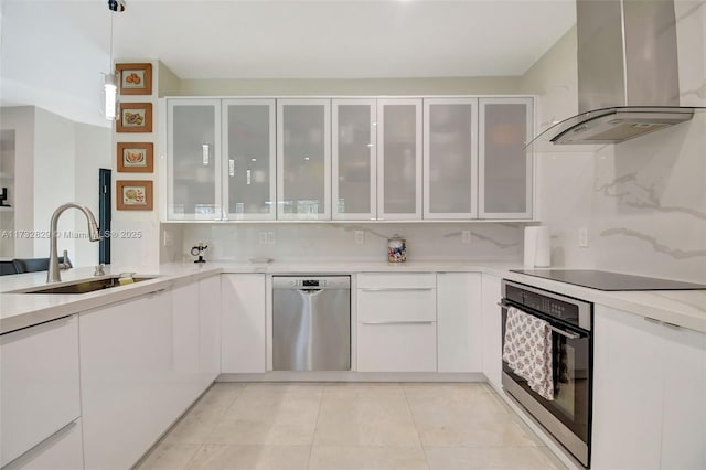 kitchen with sink, white cabinetry, ventilation hood, hanging light fixtures, and appliances with stainless steel finishes