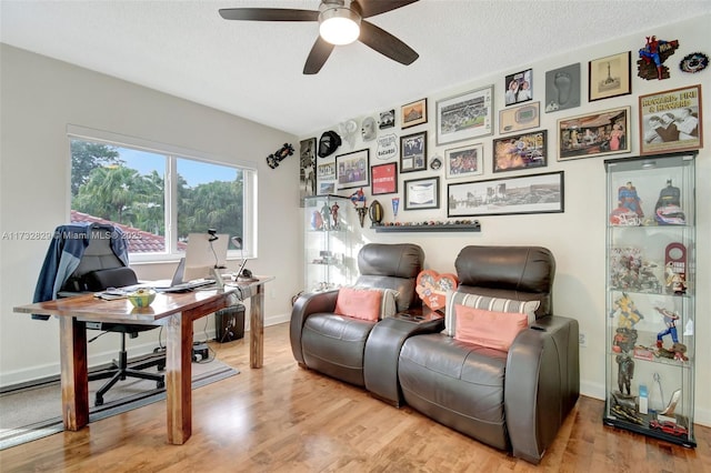 office with ceiling fan, a textured ceiling, and light hardwood / wood-style flooring