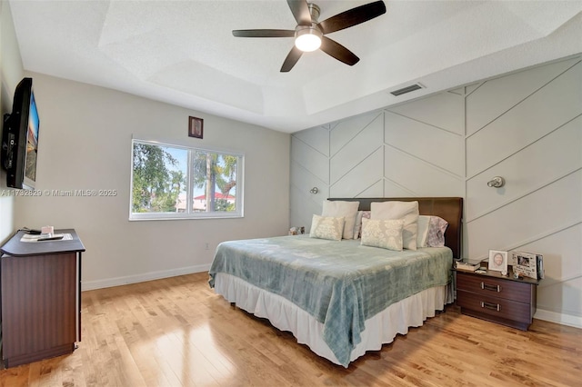 living room with lofted ceiling, hardwood / wood-style flooring, a textured ceiling, and ceiling fan