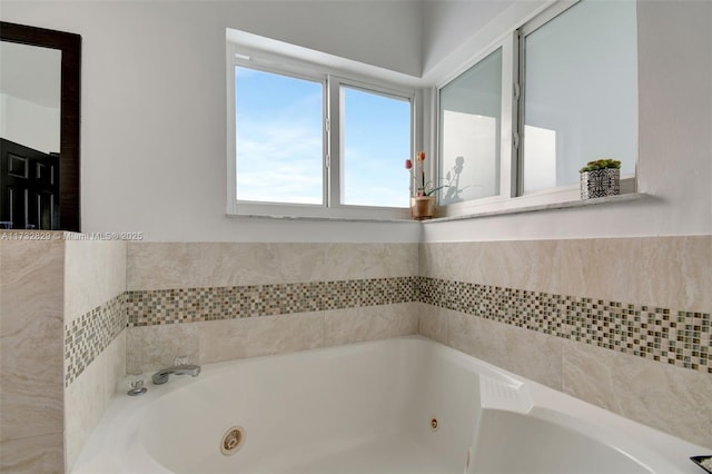 bathroom featuring vanity, tile patterned flooring, and a relaxing tiled tub