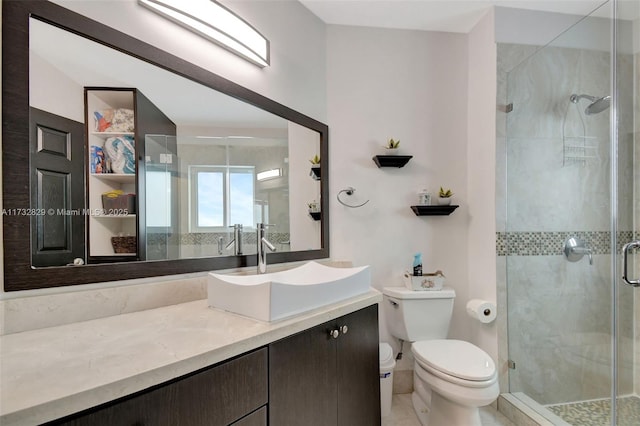 bedroom with ensuite bathroom, hardwood / wood-style floors, and ceiling fan