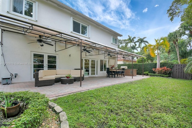 back of house featuring a patio, a lawn, an outdoor hangout area, ceiling fan, and french doors