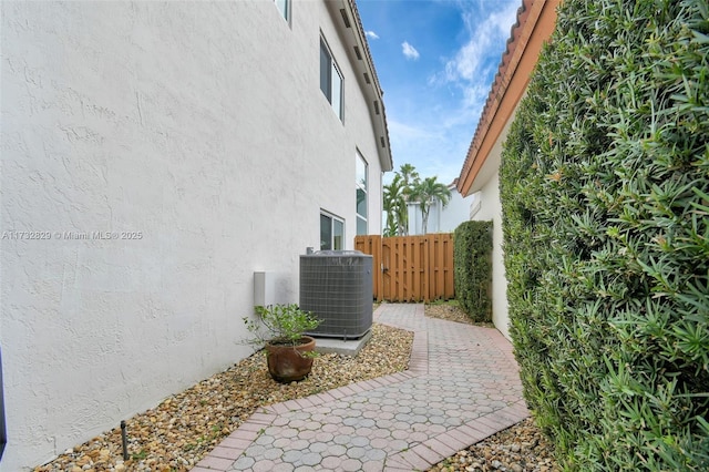 view of property exterior featuring central AC unit and a patio area