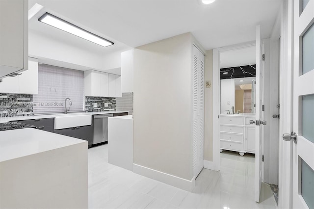 kitchen with sink, decorative backsplash, dishwasher, and white cabinets