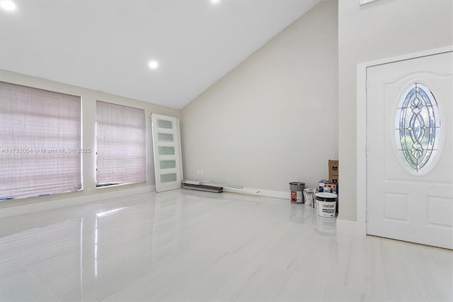 foyer featuring vaulted ceiling and light tile patterned flooring