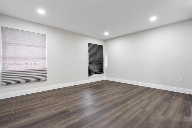 spare room featuring dark wood-type flooring