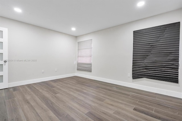 spare room with hardwood / wood-style floors