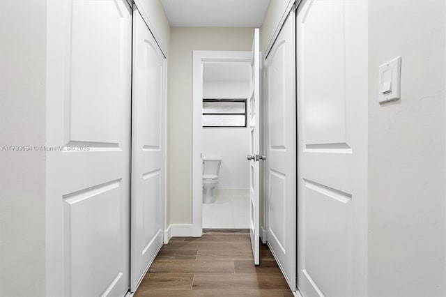 hallway with wood-type flooring