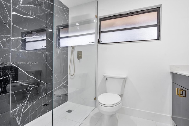 bathroom with tile patterned flooring, vanity, toilet, and a shower