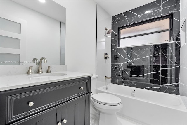 full bathroom featuring vanity, toilet, and tiled shower / bath