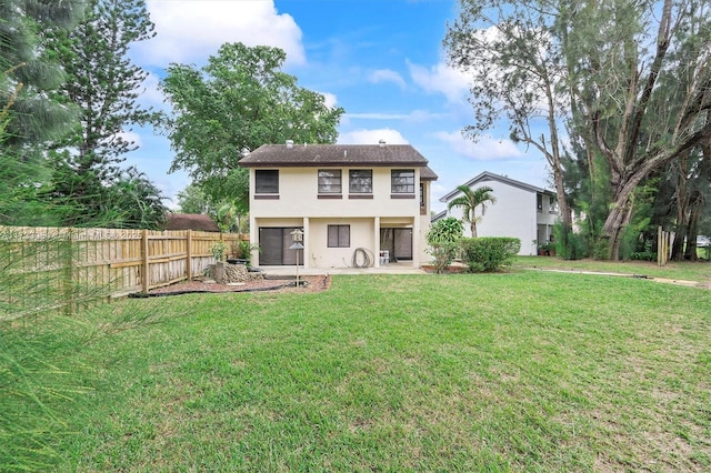 rear view of property featuring a lawn