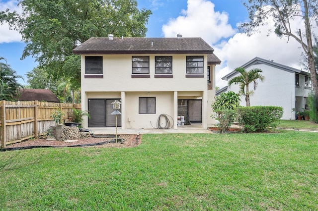 back of property featuring a yard, a patio, and a garage