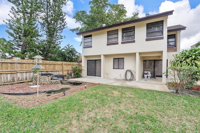 back of property featuring a yard and a patio