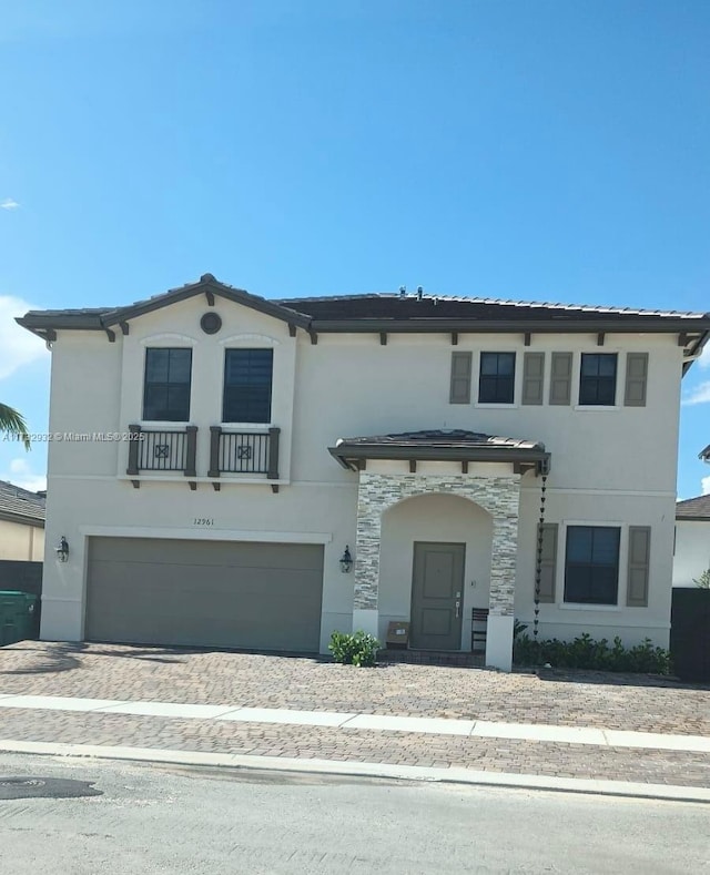 mediterranean / spanish house with a garage