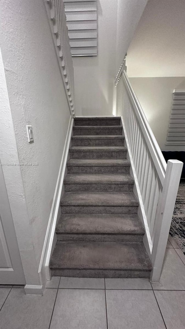 staircase with tile patterned floors