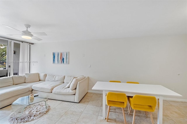 living room featuring light tile patterned floors, baseboards, and ceiling fan