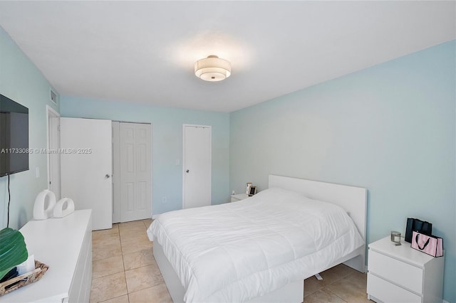 bedroom featuring light tile patterned floors and visible vents