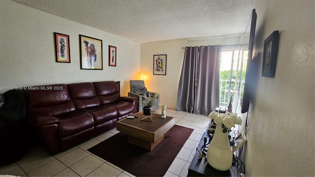 living area with a textured ceiling and tile patterned floors