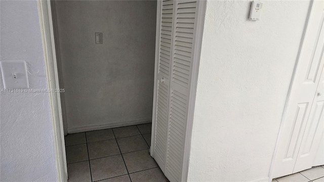 hallway with tile patterned floors