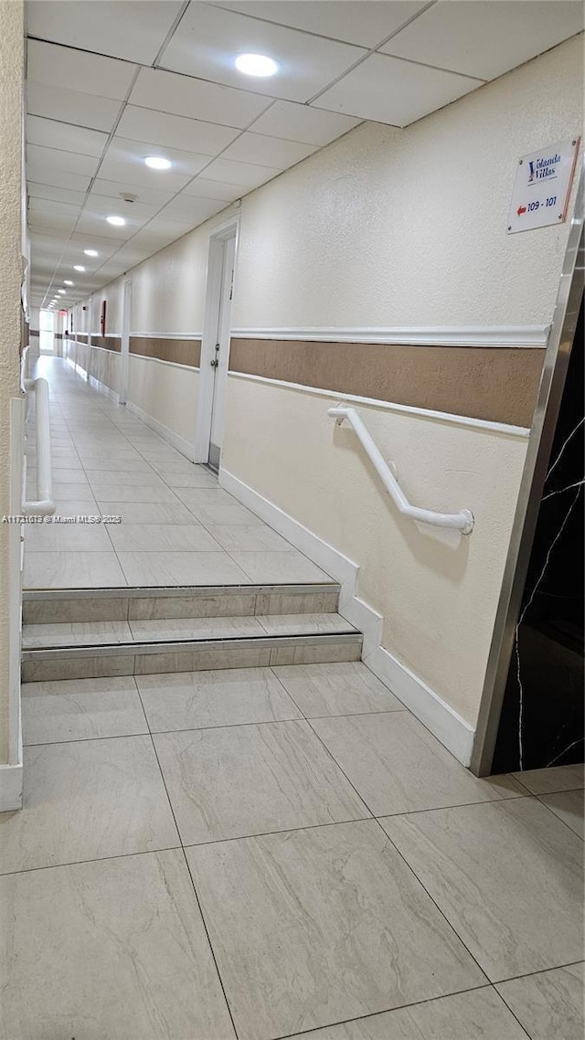 corridor featuring a paneled ceiling