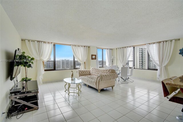 living room featuring light tile patterned flooring and a textured ceiling