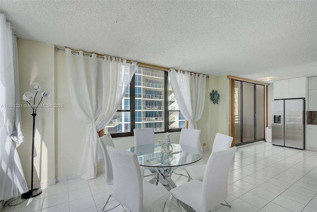 dining room featuring light tile patterned floors and a textured ceiling