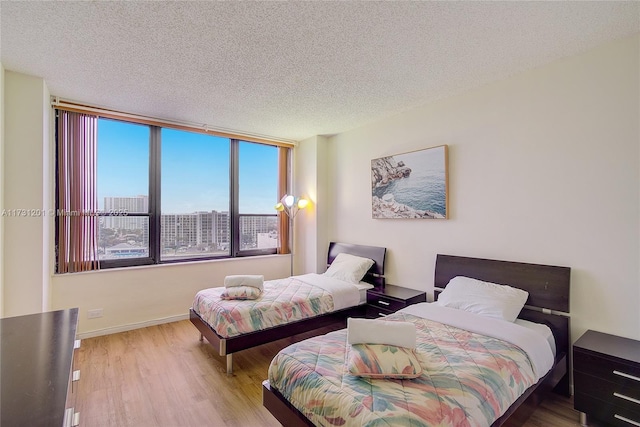 bedroom featuring a textured ceiling and light wood-type flooring