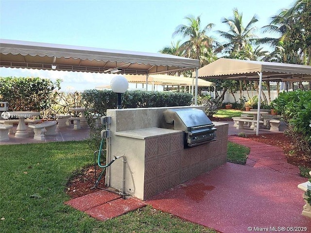 view of patio with exterior kitchen, a gazebo, and area for grilling