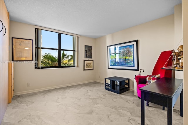300 Three Islands Blvd Unit 102, Hallandale Beach, FL 33009 - living area with marble finish floors, baseboards, and a textured ceiling