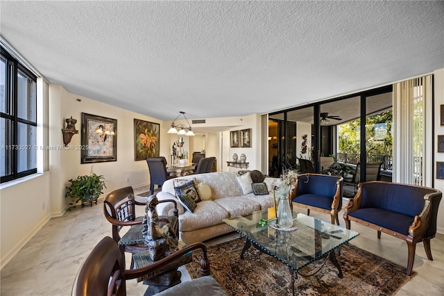 living room with expansive windows, visible vents, a textured ceiling, and baseboards