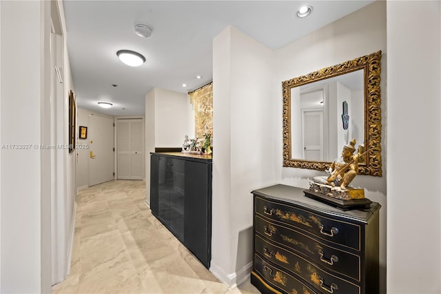 hallway featuring marble finish floor