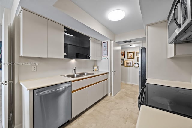 300 Three Islands Blvd Unit 102, Hallandale Beach, FL 33009 - kitchen with appliances with stainless steel finishes, a sink, light countertops, and white cabinets