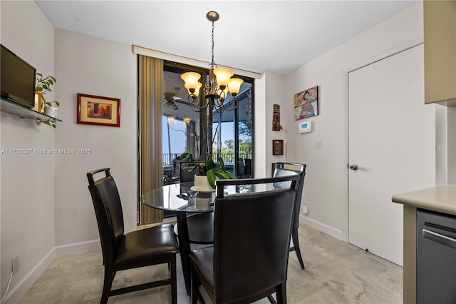 dining area with a chandelier and baseboards