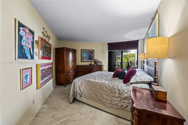 bedroom with access to outside and baseboards