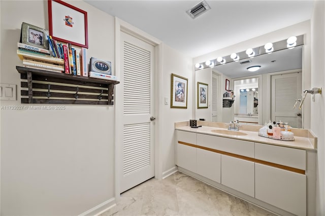 bathroom with marble finish floor, visible vents, vanity, and baseboards