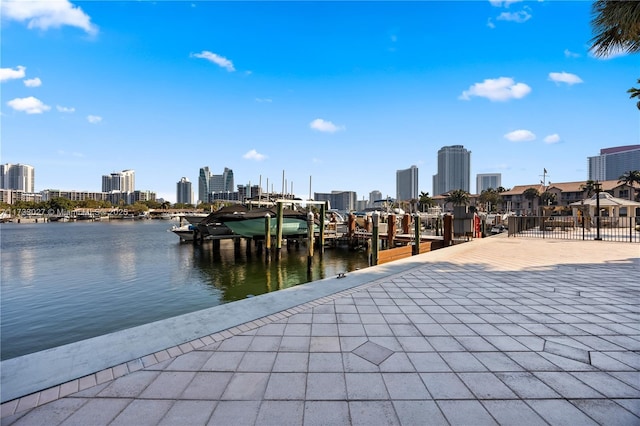 view of dock with a view of city and a water view