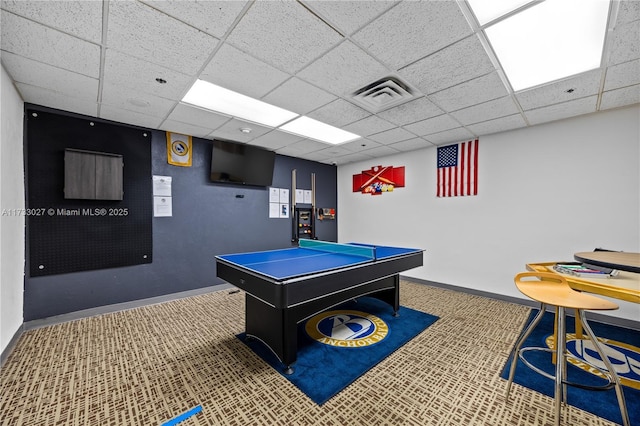 recreation room with a drop ceiling, visible vents, and baseboards