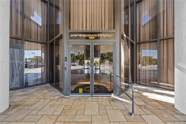 view of exterior entry with stucco siding and french doors