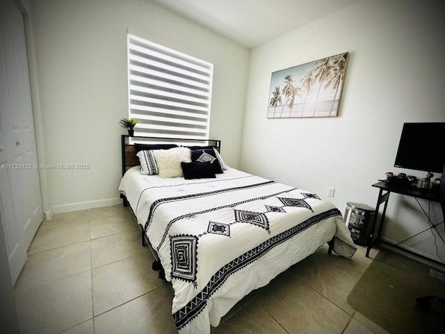 bedroom featuring light tile patterned floors and a closet