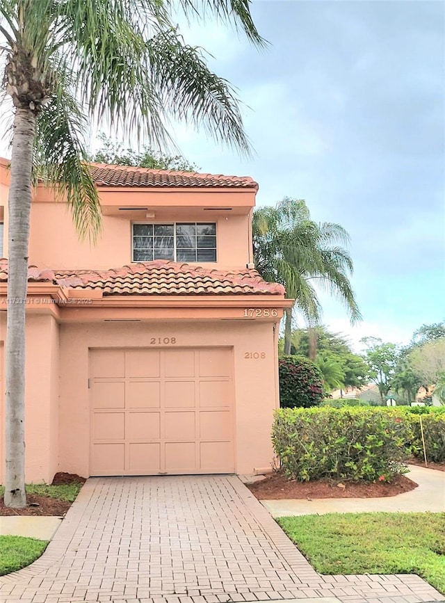 mediterranean / spanish-style home with a garage