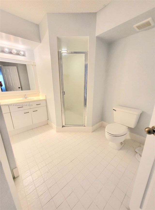 bathroom with a shower with door, vanity, and toilet