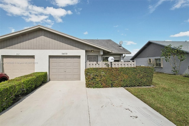 ranch-style house featuring a garage and a front lawn