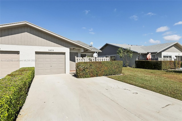 ranch-style home featuring a garage and a front lawn