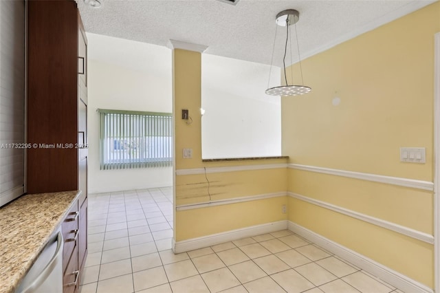 interior space featuring dishwasher, a textured ceiling, hanging light fixtures, and light tile patterned floors