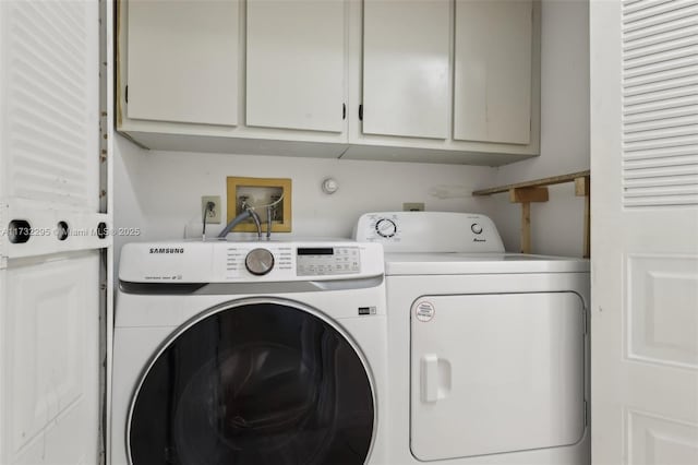 laundry room with cabinets and separate washer and dryer